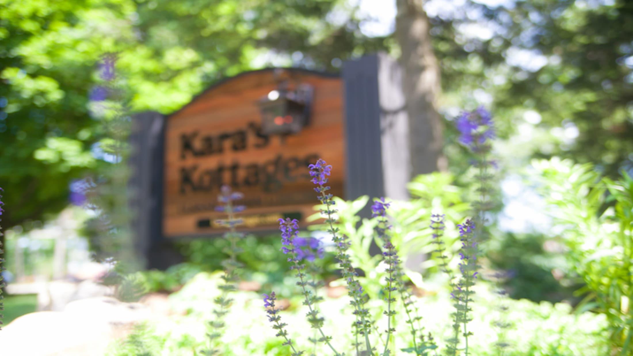 purple-flowers-in-front-of-Kara's-Kottages-sign.jpg